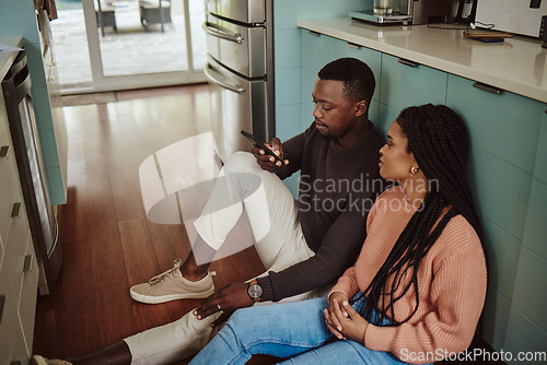 Image of Black couple, phone and kitchen floor while online on internet together for social media or ecommerce. Young man and woman talking while at home to bond, relax and use wifi for communication app