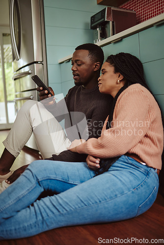 Image of Black couple, phone and streaming with home wifi while online on internet together for social media or online shopping. Young man and woman talking while at home to relax and use communication app