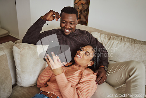 Image of Black couple, phone and lounge couch while using home wifi for streaming internet or communication. Young man and woman talking while at home for social media app, online shopping and to relax