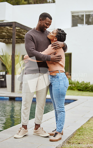 Image of Black couple, house and swimming pool property while outdoor for a hug, love and care while happy about real estate. Man and woman at their new home with pride and smile for mortgage loan approval