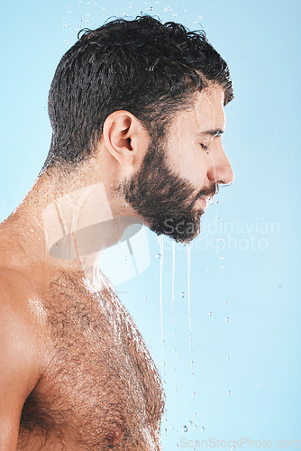 Image of Water drops, face and man in shower for skincare, cleaning body and hygiene grooming against studio background. Clean, model profile with water and facial, natural treatment and cosmetic care