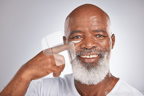 Image of Beauty, facial cream and skincare of black man in studio for self care with lotion, dermatology and cosmetics. Face portrait of happy senior male with a product on skin for glow, health and wellness