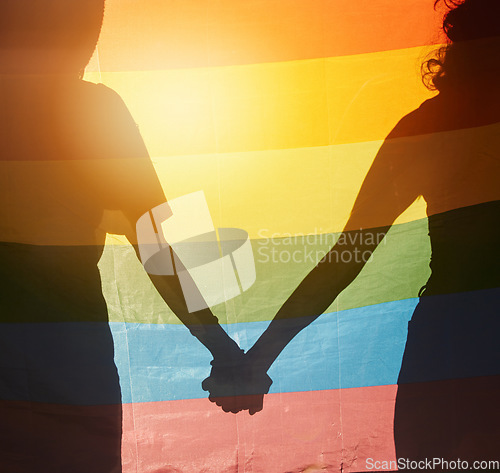 Image of LGBT, rainbow flag and couple silhouette holding hands for gay pride, non binary support or lesbian love. LGBTQ community, overlay and queer people together in solidarity, partnership and equality