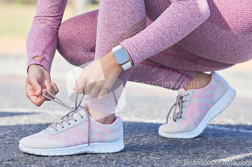 Image of Woman, shoes lace and fitness run outdoor for cardio training workout, sports exercise and runner sneakers wellness in street. Running marathon, ready and feet zoom or sportswear shoe check in city