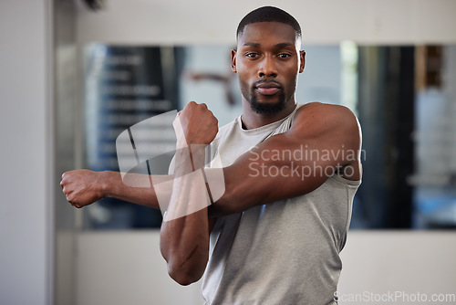 Image of Gym portrait and black man stretching arms for bodybuilder fitness and muscle warm up with focus. Training, wellness and athlete man workout preparation for exercise lifestyle at health club.