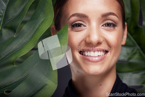 Image of Beauty, skin and face with leaf and woman, skincare with nature aesthetic, natural cosmetics and facial portrait against studio background. Smile, glow with organic cosmetic treatment and wellness.