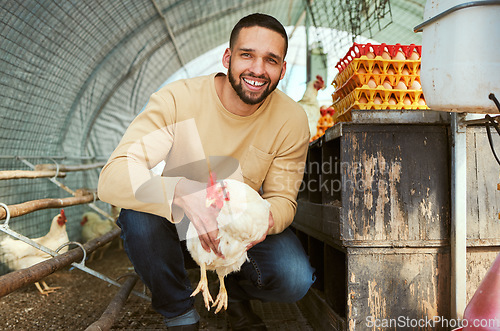 Image of Chicken farmer, poultry farming and man with animals, smile and happiness while working in the countryside for sustainability. Portrait of farm worker with animal for egg, meat and protein production