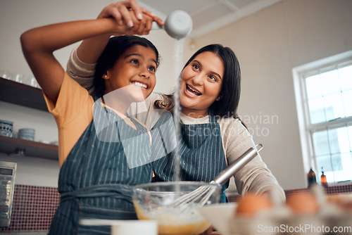 Image of Baking, girl learning and mother with kitchen cooking, flour and home development of a kid and mom. House, parent care and child making cookies, cake or sweet food with a smile, love and happiness