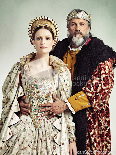 Image of Costume, portrait and king and queen in crown isolated on studio background for medieval, renaissance and fashion history. Headshot of royal couple hug with power, wealth and vintage culture and love