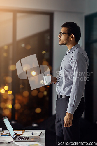 Image of Coffee, night and businessman thinking of an email on a laptop, planning and working in an office. Idea, deadline and employee with a tea drink and a computer for a proposal during overtime at work