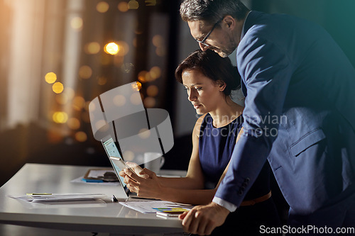 Image of Night, business and man with woman, smartphone and typing for connection, content marketing and modern office. Employees working late, manager or coworkers with tablet, conversation or online reading