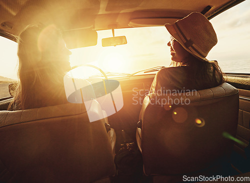 Image of Woman, friends and road trip for sunset travel, summer vacation or holiday relaxing in the car together. Happy women enjoying traveling journey, sunshine or driving freedom with lens flare by a beach