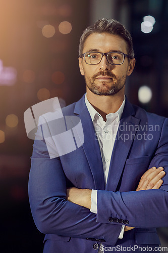Image of Confident, arms crossed and night with portrait of businessman in office for management, leadership and vision. Professional, executive and future with face of ceo focus on mindset, career or goals