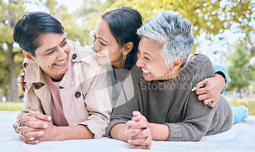 Image of Love, family and lesbian couple with adult daughter, happy and laughing, relax and talking in a park. Lgbt, happy family and woman enjoying a picnic with her mothers, cheerful and excited while lying