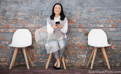 Image of Woman waiting for interview on chair with phone, recruitment and employment with smile. Portrait of happy person in Japan sitting on chair, smiling and excited for job opportunity for Japanese people