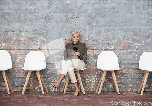 Image of Recruitment, job search and woman on brick wall sitting in line with phone for opportunity, hr email and success. Smartphone, waiting room and black people on social media for career networking app