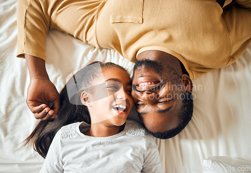 Image of Black family, father and daughter love on a bed with a smile on face or laughing at funny memory. Above man and child together in home bedroom for bonding, support and care with safety and security