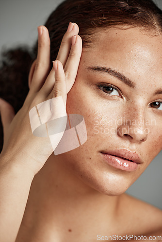 Image of Skin, beauty and black woman portrait with skincare glow from spa treatment and makeup. Model, hand and face of a person relax after dermatology detox in a studio with gray background feeling healthy