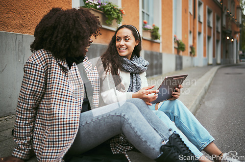 Image of Street, friends and women talking, tablet and social media for connection, conversation and bonding outdoor. Young females, ladies and device for online reading, city and girls on road and discussion