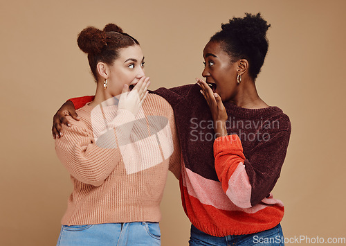 Image of Gossip, friends and surprise face of young women with a secret and brown studio background. Wow, student surprised and girl chat together with whisper and excited discussion with shock from story