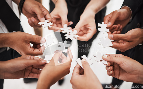 Image of Hands, puzzle and business people collaboration, teamwork and integration closeup for planning. Team, hand and synergy with problem solving, partnership and people connecting to support innovation