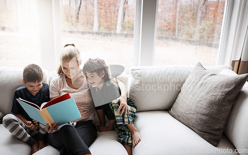 Image of Books, reading and mother with kids on sofa for storytelling time in living room of happy home. Love, learning and woman with children, book and fantasy story on couch, growth and child development.