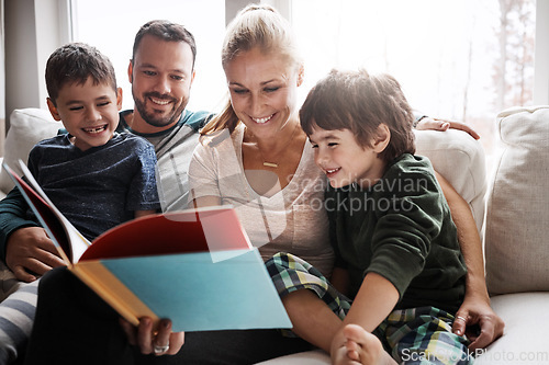 Image of Mom, dad and kids reading book on sofa, storytelling time in living room of happy family home. Love, learning to read and couple with children, book and fantasy story on couch together on weekend.