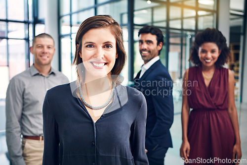 Image of Business woman, happy and leader portrait while in a office with management team for growth. Face of corporate female entrepreneur for diversity, motivation and vision for innovation in a workplace