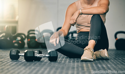 Image of Dumbbells, gym and woman on a health studio club floor ready for training and exercise. Strength challenge, healthy athlete and power workout of an athlete on the ground rest after lifting weights