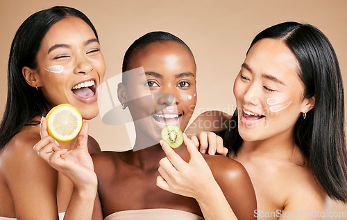 Image of Happy woman, friends and fruit for healthy skincare, nutrition or vitamin C and facial moisturizer against studio background. Portrait of female models with smile holding organic food for health diet