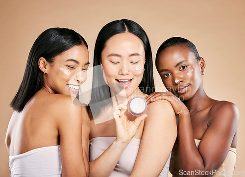 Image of Woman, skincare and face cream product in studio for wellness, skin and grooming on brown background. Facial, mask and friends relax for beauty, sunscreen and lotion, luxury and pamper while isolated