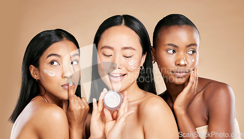 Image of Skincare, women and face cream in studio for wellness, grooming and hygiene against brown background. Friends, beauty and lotion for girl group with different, facial and skin product while isolated