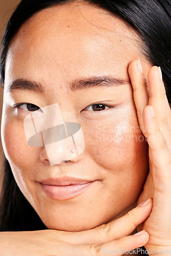 Image of Closeup portrait, hand frame and asian woman in studio with skincare, natural skin glow and smile. Happy japanese model, cosmetic beauty and healthy aesthetic with self care, wellness and headshot