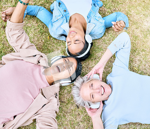 Image of Top view, senior or women and music headphones in silent disco, retirement fun or bonding community wellness. Smile, happy or elderly friends lying on grass or listening to radio in relax nature park