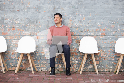 Image of Recruitment, thinking and man on brick wall sitting in line with laptop for job opportunity, hr email and success. Computer, waiting room and person on Human Resources website for career application