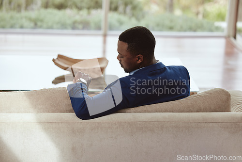 Image of Time, businessman and waiting on a sofa for appointment, meeting or property showing. Watch, realtor and black man sitting in a living room, timing, schedule and new house property investment