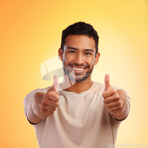 Image of Happy man, thumbs up and like emoji portrait with smile and hands for advertising sale or promotion. Face of winner person for thank you, review or yes sign on yellow studio background for motivation