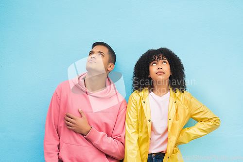 Image of Thinking, mockup and fashion with a black couple on a blue background in studio branding or product placement. Wall, style and mock up with a man and woman posing on blank space in trendy clothes