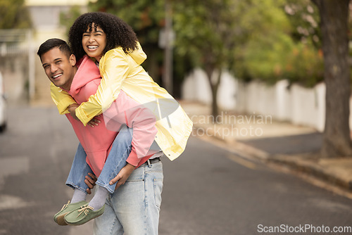 Image of Black couple, piggyback and portrait of young people with love, care and bonding in a street. Urban, happy and black woman and man together with a smile and happiness loving summer fun outdoor