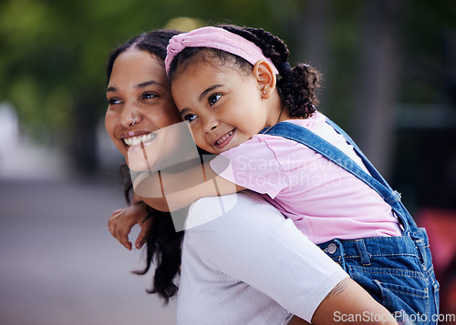 Image of Mom, girl child and happy with piggyback ride in urban park, street and outdoor for love, bonding and care. Family, mother and daughter with smile, riding back or happiness on vacation, relax or walk