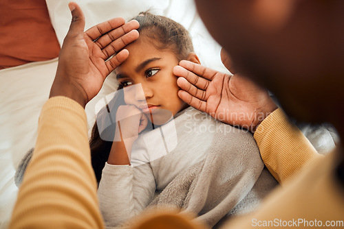 Image of Sick, girl and father checking high temperature with hands on ill kid or daughter lying on a bed feeling sad. Concern, care and parent in bedroom with worried child with flu, cold or fever