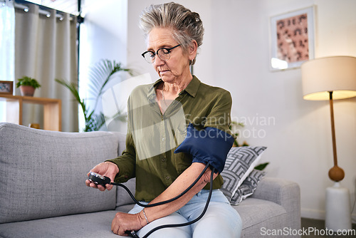 Image of Healthcare, machine and senior woman with hypertension, health monitor and test for blood pressure. Medicine, check and sick elderly person reading information on a device for a medical problem