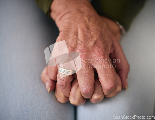 Image of Senior woman, anxiety and hands on lap for worry, concern and stress waiting for medical results. Healthcare, mental health and zoom of elderly female with anxious, nervous body gesture and sad news