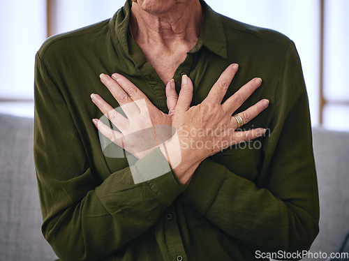 Image of Senior woman, health and hands on chest for breathing exercise, cardiology care and wellness at home. Healthcare, heart support and elderly female on sofa holding body to breathe, relax and calm