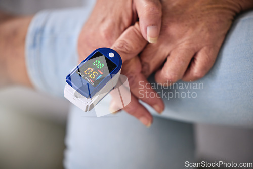 Image of Pulse oximeter, healthcare and woman taking her heart rate in a retirement home during consultation. Medical, treatment and senior female patient measuring her oxygen blood levels with health device.