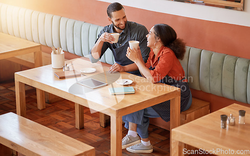 Image of Coffee, cafe and barista couple at table drinking, talking and laughing at funny meme. Small business, owners or happy man and woman on break with caffeine or espresso while having comic conversation