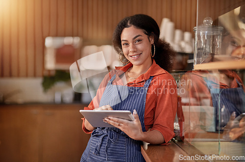 Image of Portrait, cafe waiter and black woman with tablet to manage orders, inventory and stock. Coffee shop barista, technology and happy female waitress with touchscreen for managing sales in restaurant.
