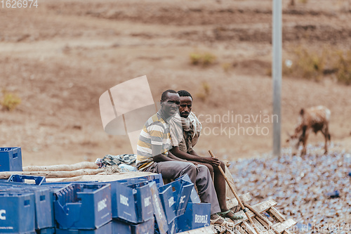 Image of Truck drivers sitting on spilled cargo, Gondar Ethiopia