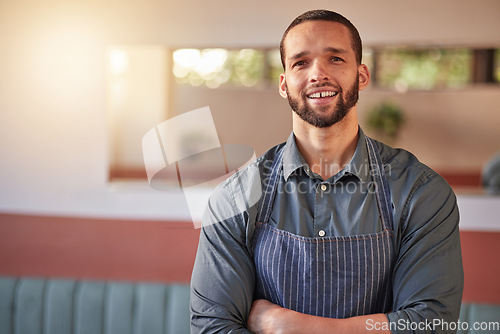 Image of Restaurant, waiter portrait and man with arms crossed ready to take your order. Small business, server and confident, happy and proud young male employee from Brazil, worker or startup business owner