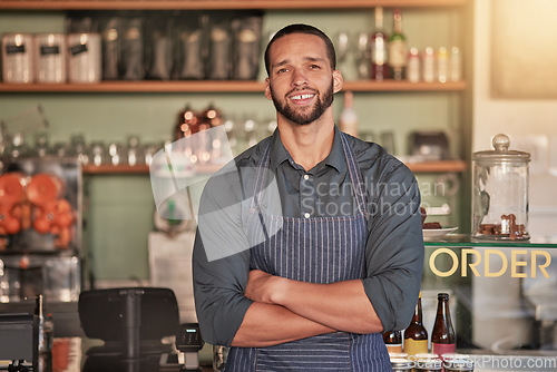Image of Portrait, cafe and barista man with arms crossed ready to take your order. Coffee shop, waiter and confident, happy and proud young male employee from Brazil or small business owner of cafeteria.